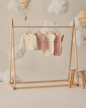 Load image into Gallery viewer, Natural scalloped cardigan by Quincy Mae, soft knit fabric, displayed on a wooden rack with a cozy, casual style.