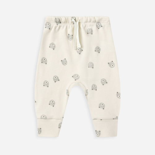 White baby pants with small green patterns on a white background