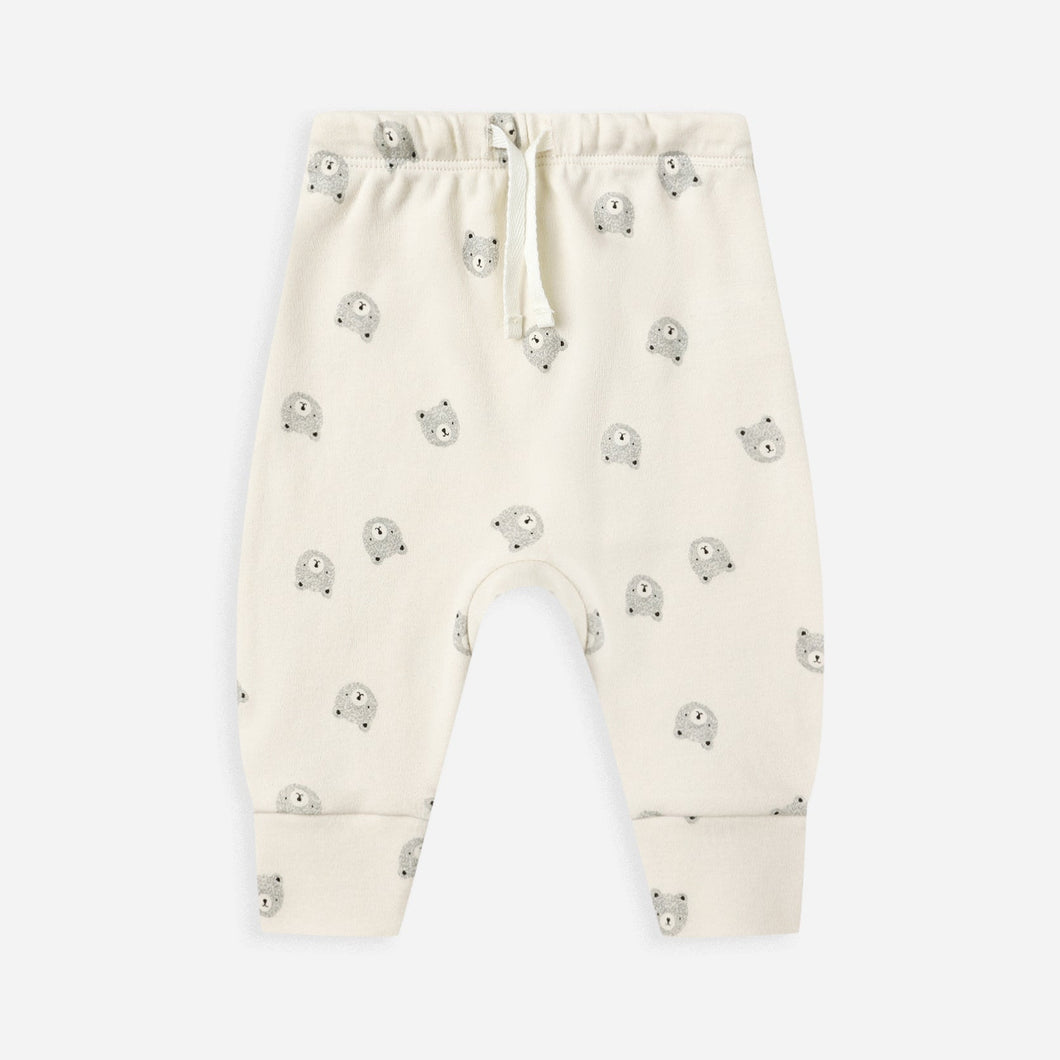 White baby pants with small green patterns on a white background