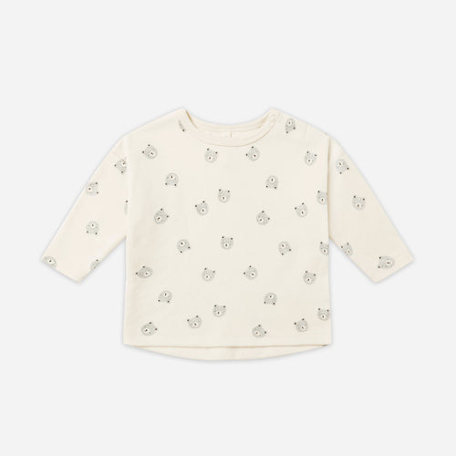 Beige long-sleeve shirt with small print on a white background