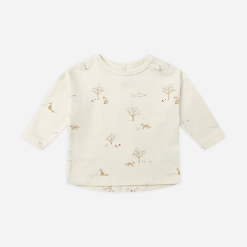 Baby sweater with subtle pattern on a white background