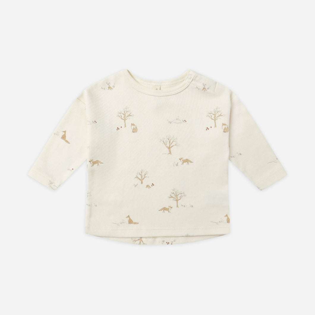 Baby sweater with subtle pattern on a white background