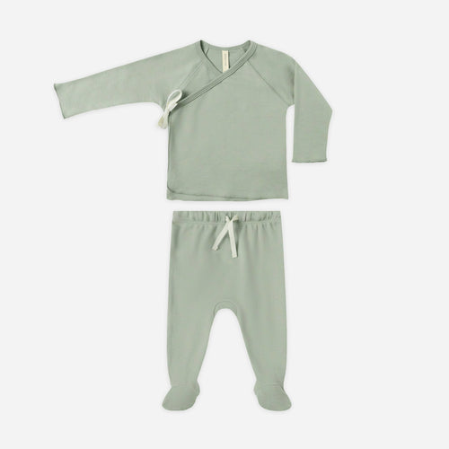 Green baby outfit with long-sleeve top and footed pants on a white background