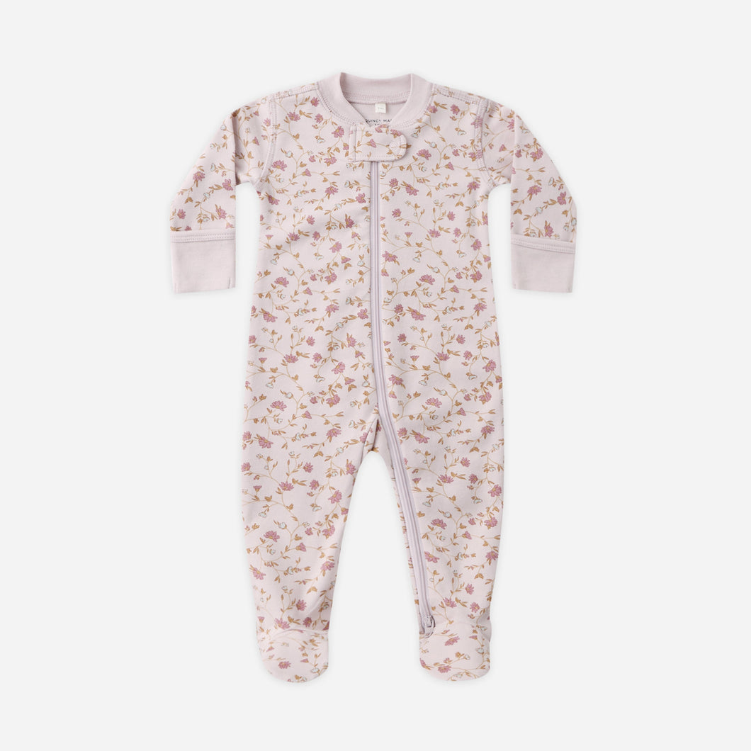 Floral patterned baby onesie on a white background
