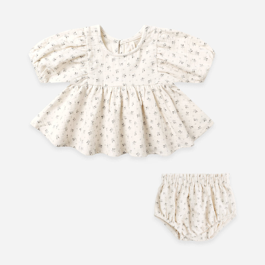 Baby girl's outfit with top and bloomers on a light gray background