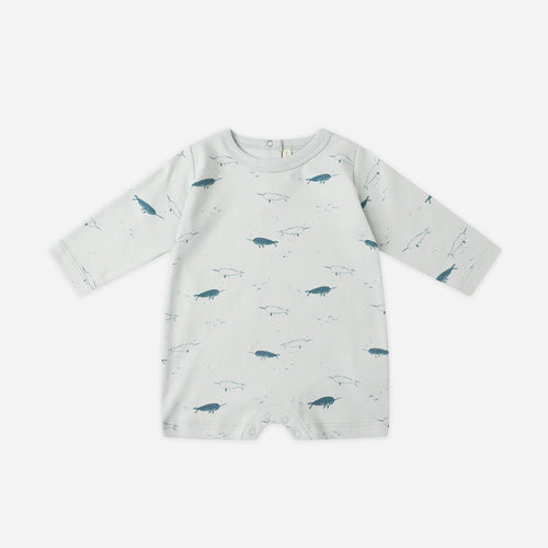 Baby romper with whale pattern on a white background