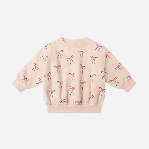 Pink sweatshirt with bow pattern on a white background