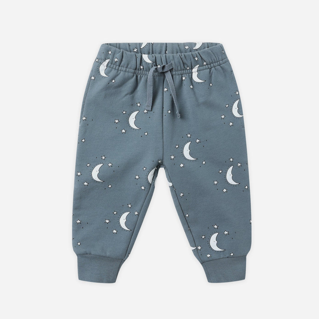 Blue children's pants with moon pattern on a white background