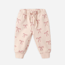 Load image into Gallery viewer, Pink baby pants with bow pattern on a white background