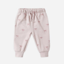 Load image into Gallery viewer, Pink baby pants with bow pattern on a white background