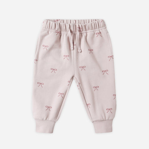 Pink baby pants with bow pattern on a white background