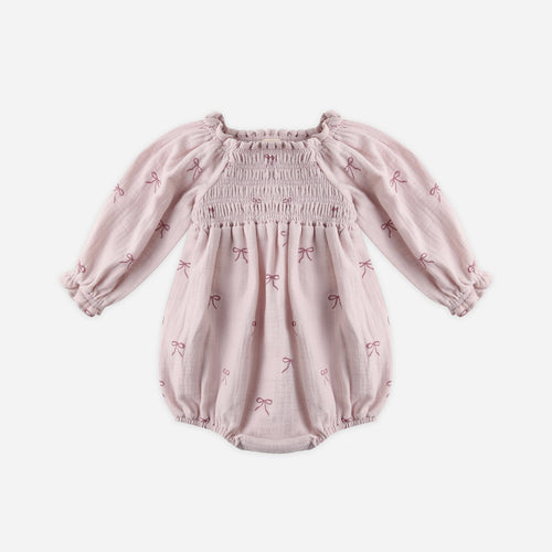 Pink baby romper with long sleeves on a white background