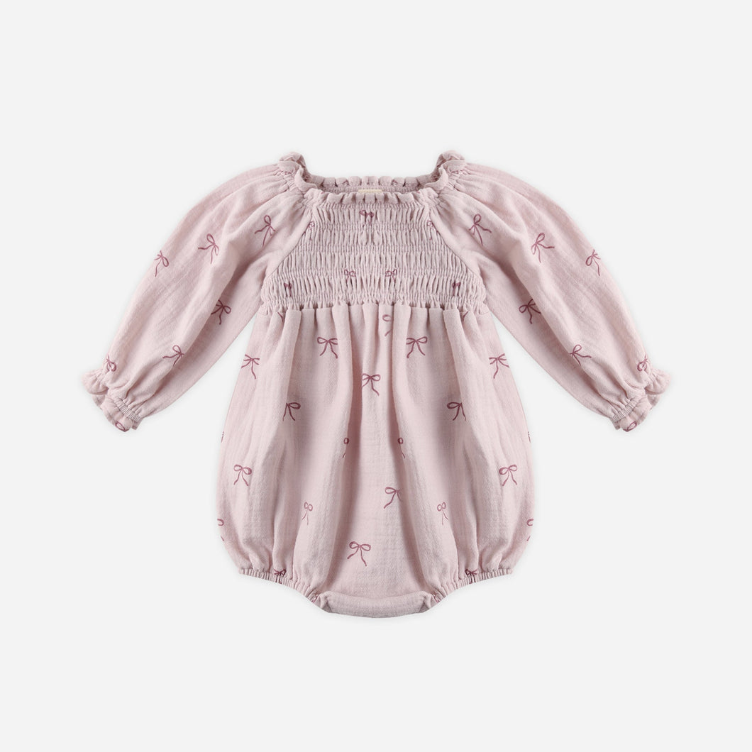 Pink baby romper with long sleeves on a white background