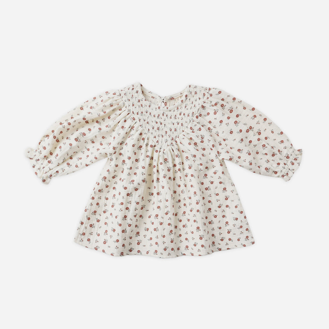 Floral patterned blouse on a white background