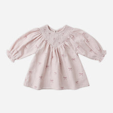 Load image into Gallery viewer, Pink baby dress with bow pattern on a white background