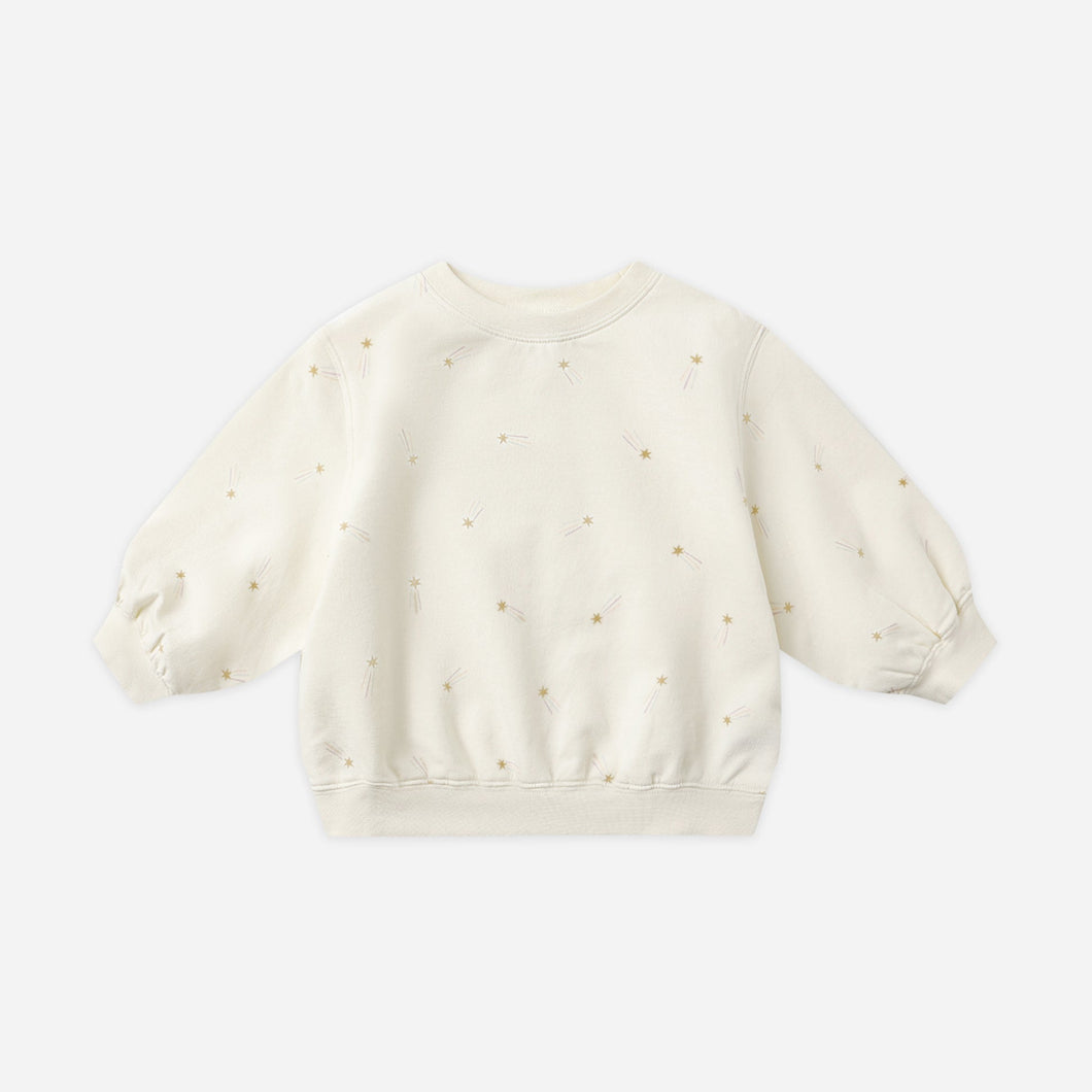 White baby sweater with small patterns on a light gray background