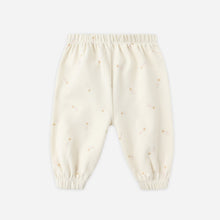 Load image into Gallery viewer, Cream-colored baby pants with small patterns on a white background