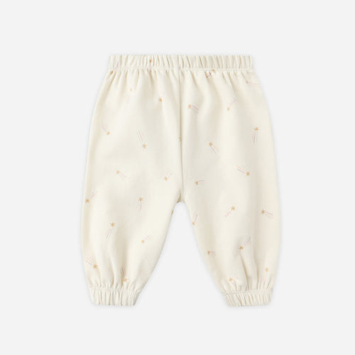 Cream-colored baby pants with small patterns on a white background