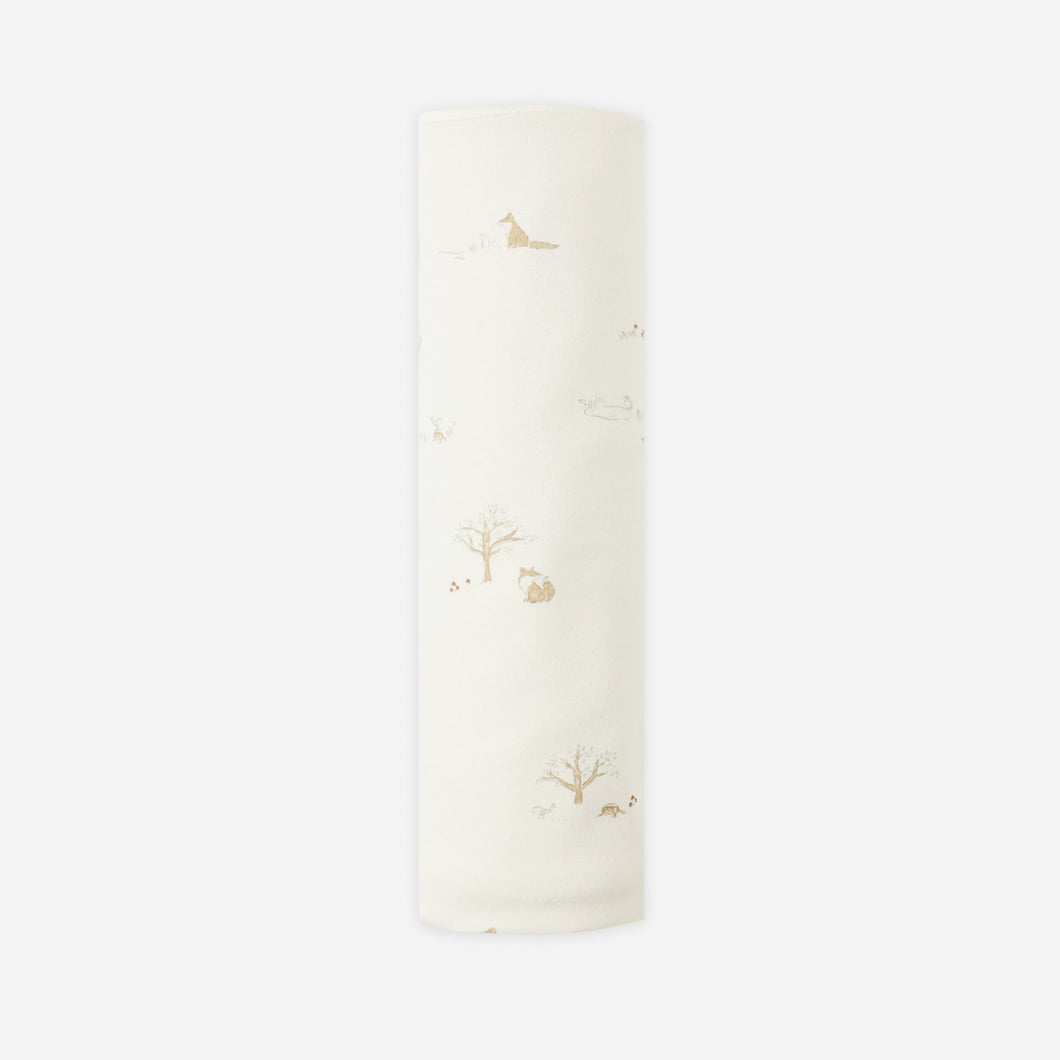 White candle with floral design on a white background