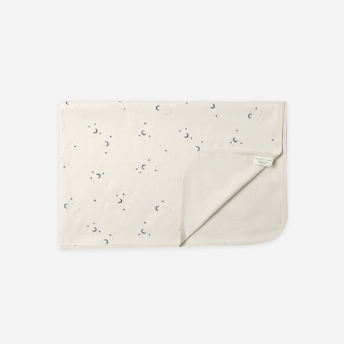 Beige clutch bag with subtle pattern on a white background