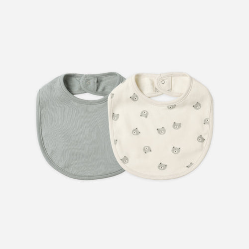 Two baby bibs, one gray and one white with a pattern, on a white background