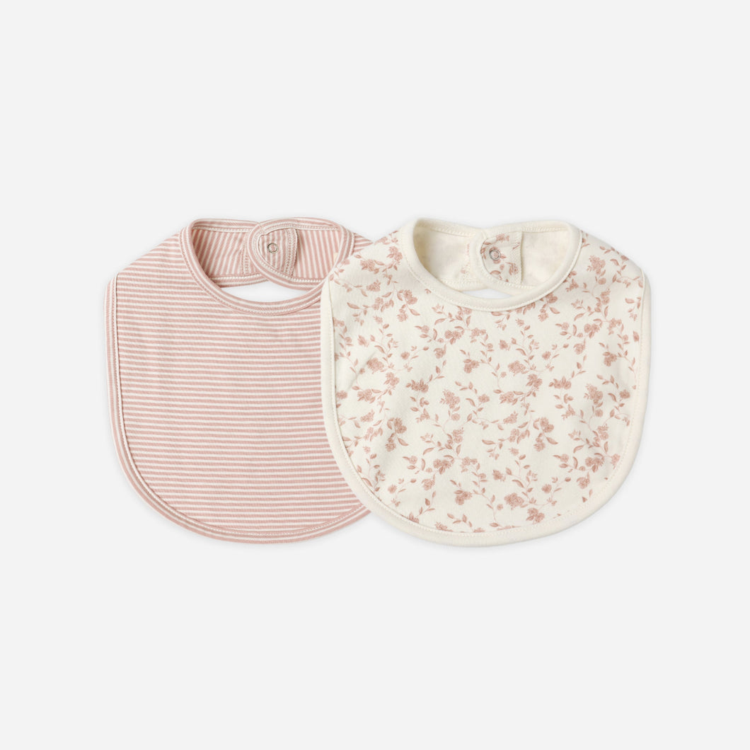 Two baby bibs, one pink with stripes and one floral pattern, on a white background.