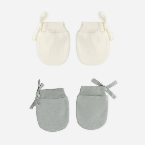 Set of two pairs of baby mittens, one cream and one gray, on a white background.