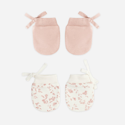 Set of two pairs of baby mittens on a white background