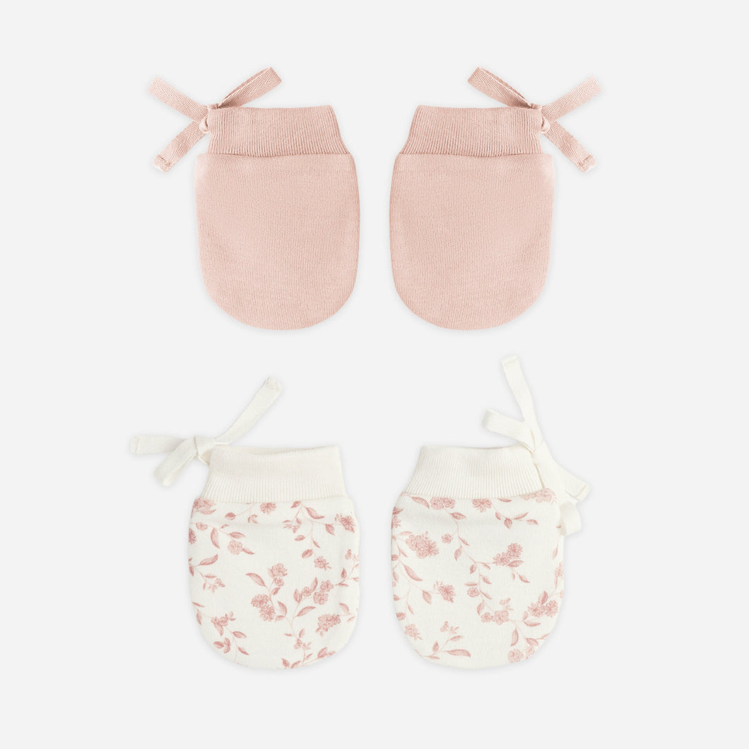 Set of two pairs of baby mittens on a white background