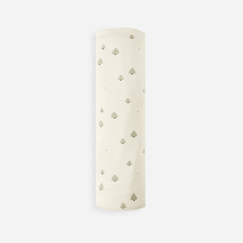 White cylindrical object with small holes on a light beige background