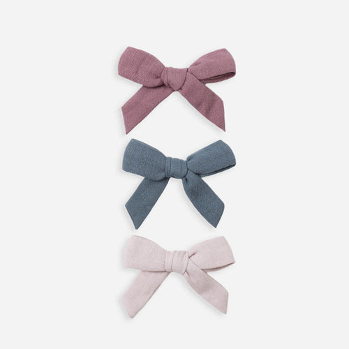 Three fabric bows in different colors on a white background