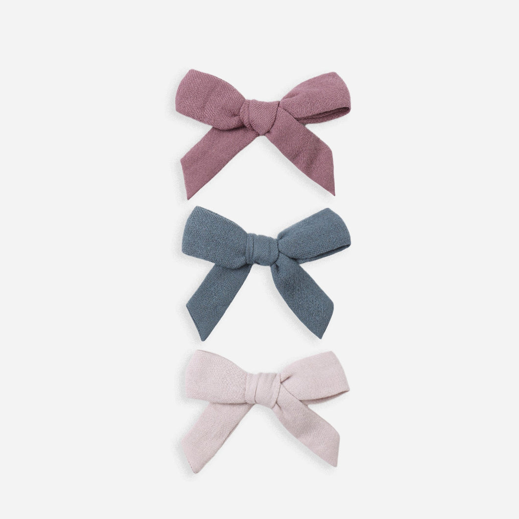 Three fabric bows in different colors on a white background