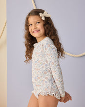 Load image into Gallery viewer, Baby girl wearing Rylee+Cru Bloom one-piece rashguard swimwear with long sleeves and colorful floral pattern.