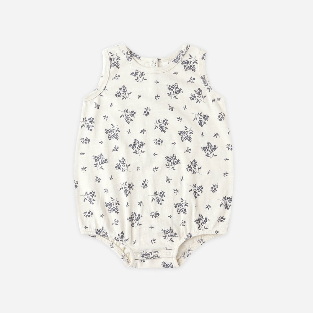 Floral-patterned baby romper on a white background