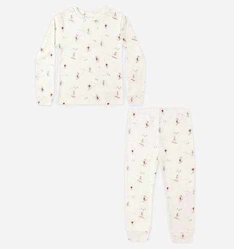 White pajama set with small red patterns on a white background