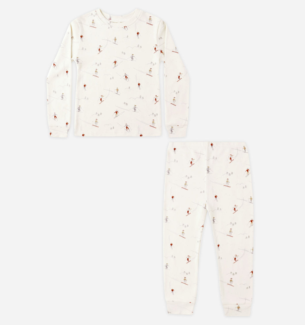White pajama set with small red patterns on a white background