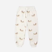 Load image into Gallery viewer, Cream-colored sweatpants with small patterns on a white background