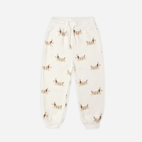 Cream-colored sweatpants with small patterns on a white background