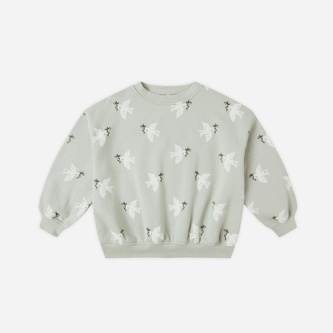 Light green sweater with butterfly pattern on a white background