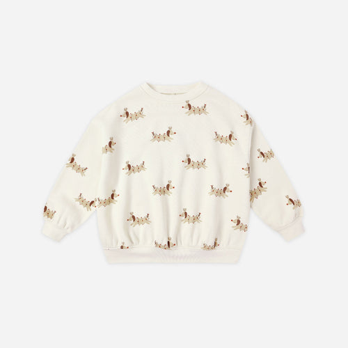 White sweater with small patterns on a light beige background