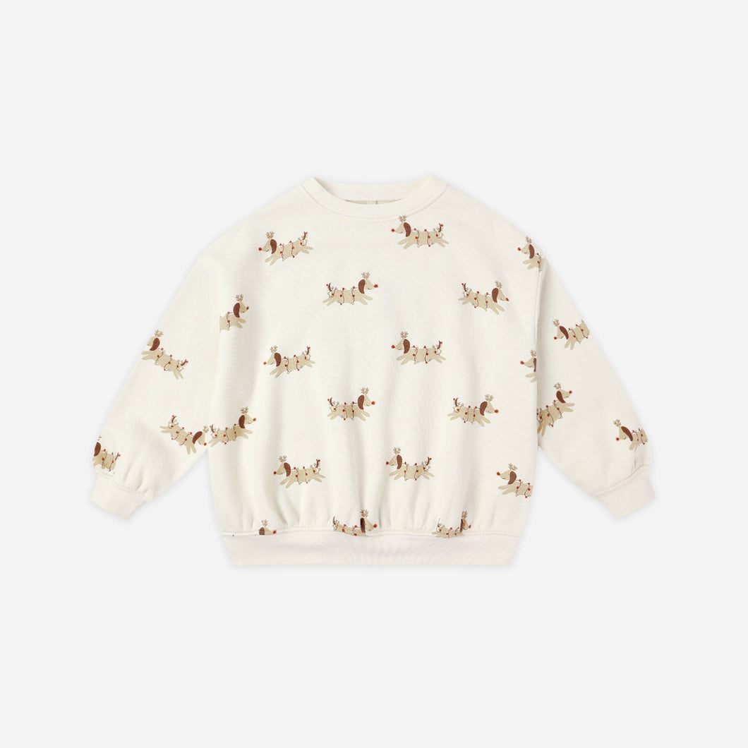 White sweater with small patterns on a light beige background