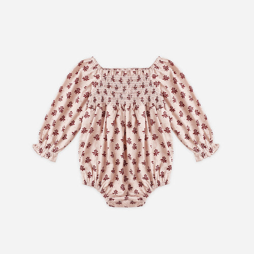 Pink floral baby romper on a white background
