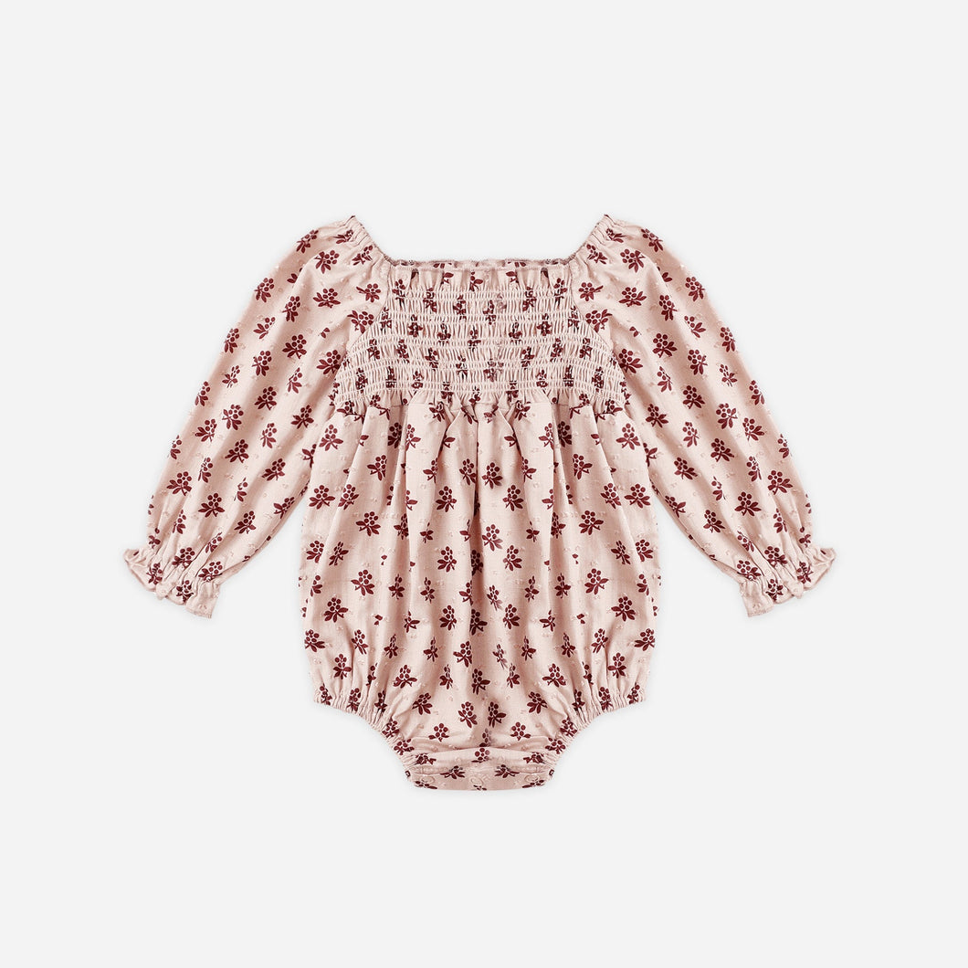 Pink floral baby romper on a white background