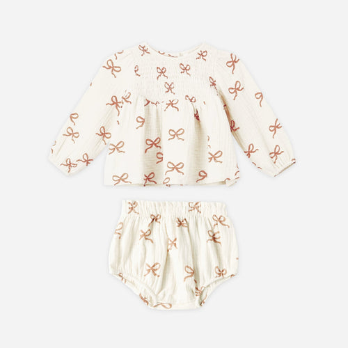 Baby outfit set with hat and bloomers on a white background