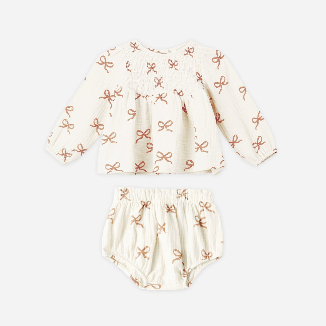 Baby outfit set with hat and bloomers on a white background