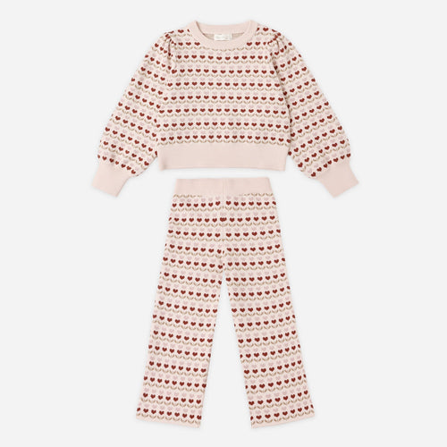 Pink and red patterned pajama set on a white background