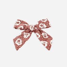 Load image into Gallery viewer, Decorative bow with skull pattern on a white background