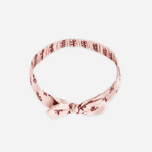 Rose gold headband on a white background
