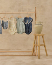 Load image into Gallery viewer, Rylee+Cru Porter Romper Ditsy featuring a floral print, short sleeves, and a relaxed fit, laid flat on a neutral background.
