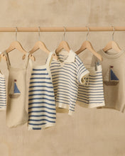 Load image into Gallery viewer, Rylee+Cru Chandler Knit Polo top in marine stripe with a classic collar and short sleeves, displayed on a hanger.